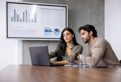 Woman and man looking a laptop.